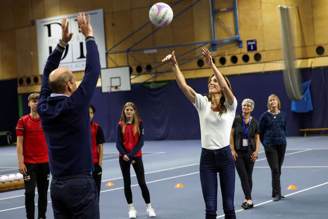 <p>SUZANNE PLUNKETT/POOL/AFP via Getty</p> Kate Middleton and Prince William play netball at a mental fitness workshop run by SportsAid at Bisham Abbey National Sports Centre on Oct. 12