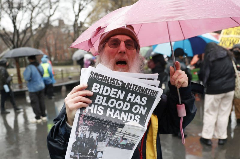 Protesters hold signs and umbrellas as rain falls at the Hands Off Rafah Ceasefire Now Stop The Genocide protest in response to the Israeli-Palestinian conflict in Washington Square Park on Saturday, March 2, 2024 in New York City. Photo by John Angelillo/UPI