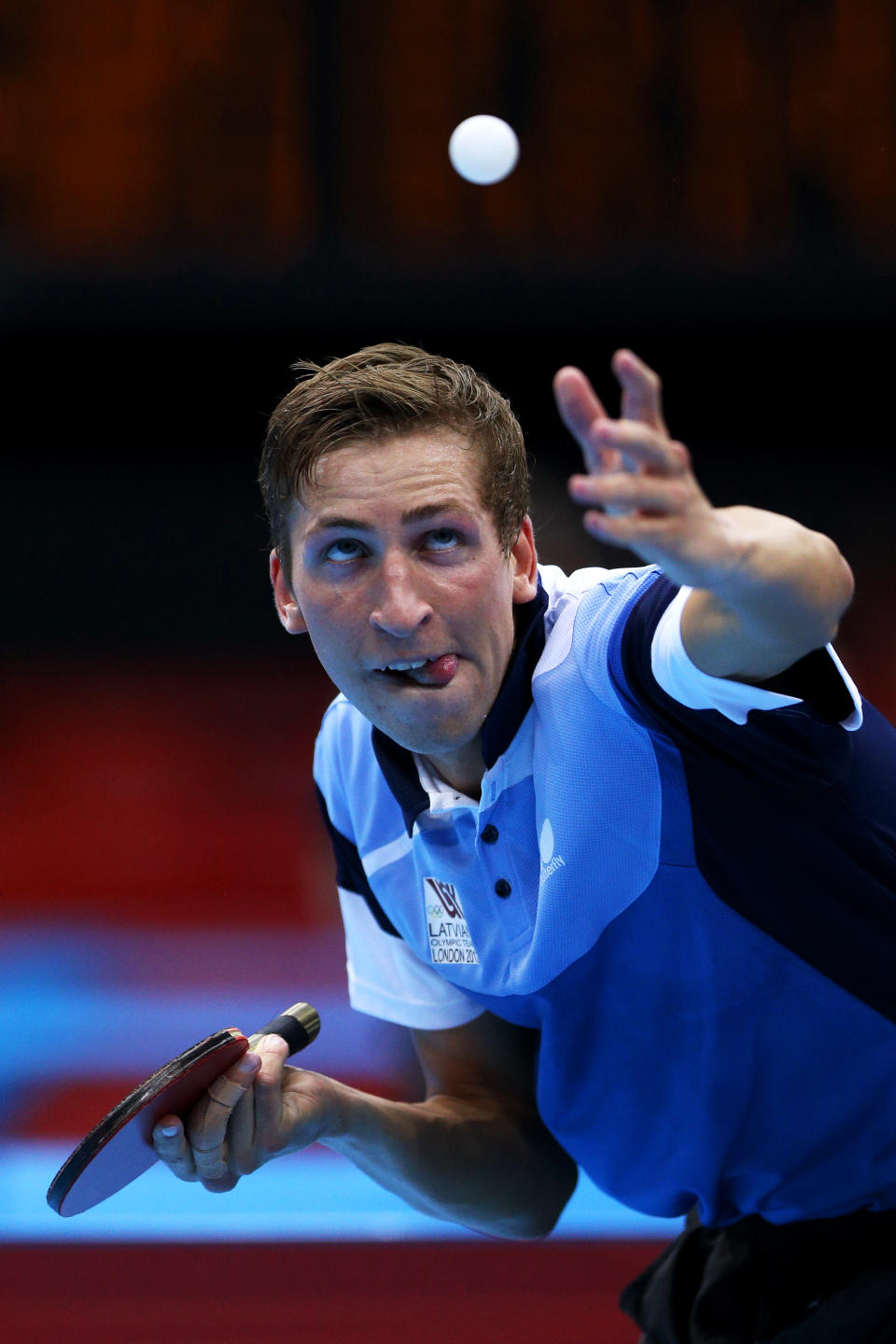 LONDON, ENGLAND - JULY 28: Matiss Burgis of Latvia serves against Pierre-Luc Hinse of Canada during their Men's Singles Table Tennis match on Day 1 of the London 2012 Olympic Games at ExCeL on July 28, 2012 in London, England. (Photo by Feng Li/Getty Images)