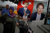 People pass by an election poster of Iyi (Good) Party leader and presidential candidate Meral Aksener in Istanbul, Turkey June 23, 2018. REUTERS/Alkis Konstantinidis