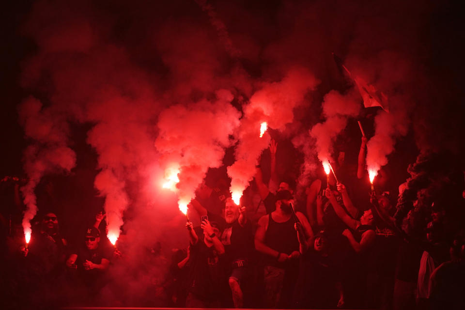 Fans light flares during the first half of a Leagues Cup soccer match between the Los Angeles FC and the Club America Wednesday, Aug. 3, 2022, in Inglewood, Calif. (AP Photo/Mark J. Terrill)
