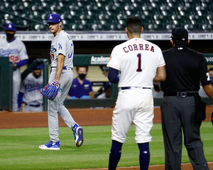 HOUSTON, TEXAS - JULY 28: Joe Kelly #17 of the Los Angeles Dodgers has a word with Carlos Correa #1 of the Houston Astros as he walks off the mound after a series of high inside pitches in the sixth inning at Minute Maid Park on July 28, 2020 in Houston, Texas. Both benches emptied. (Photo by Bob Levey/Getty Images)