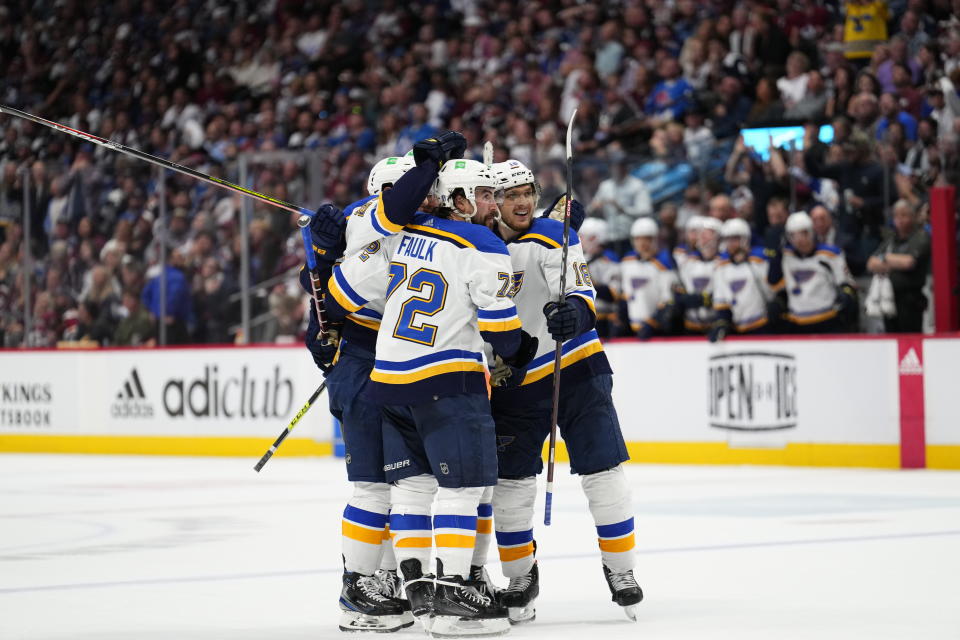 St. Louis Blues defenseman Justin Faulk (72) and Robert Thomas (18) and teammates celebrate a Blues power-play goal against the Colorado Avalanche during the third period in Game 1 of an NHL hockey Stanley Cup second-round playoff series Tuesday, May 17, 2022, in Denver. (AP Photo/Jack Dempsey)