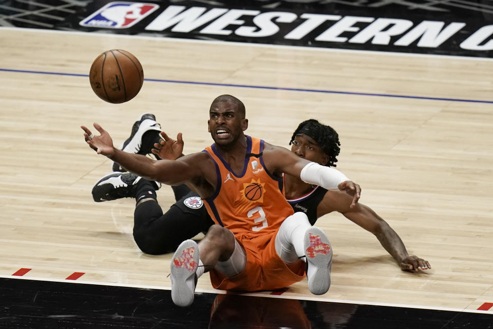 Phoenix Suns' Chris Paul retrieves the ball against Los Angeles Clippers' Terance Mann during the second half in Game 6 of the NBA basketball Western Conference Finals Wednesday, June 30, 2021, in Los Angeles. (AP Photo/Jae C. Hong)