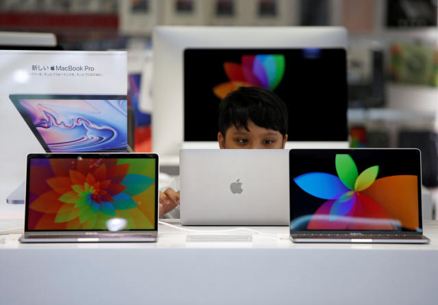 Cost of living A boy tries to use an Apple laptop at a computer shop in Tokyo, Japan, May 10, 2019.   REUTERS/Issei Kato