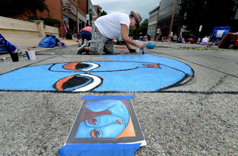 Dennis Selvaggio of Springfield works on his painting on Washington Street during Saturday's "Paint the Street" event in Springfield.