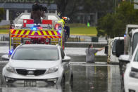 A man walks through flood waters back to his home from a fire truck at Windsor on the outskirts of Sydney, Australia, Tuesday, July 5, 2022. Hundreds of homes have been inundated in and around Australia's largest city in a flood emergency that was threatening 45,000 people, officials said on Tuesday. (AP Photo/Mark Baker)
