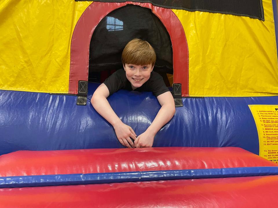 Conner Phillips, 9, takes a pause while playing on an inflatable castle at the Easter Eggstravaganza at West Towne Christian Church, April 2, 2023.