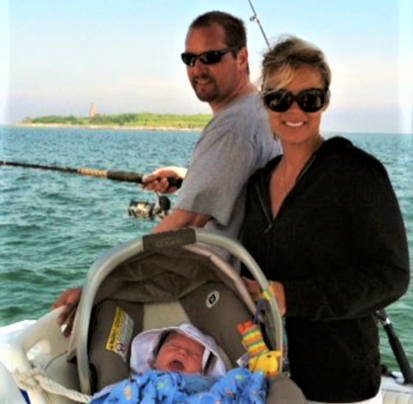 The late Alec Cyr fishes off the Maine coast with his wife, Heather, and their infant son, Chase, in 2011, four months before he died of colon cancer.