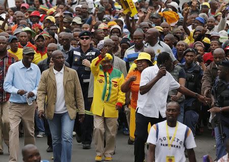 Lesotho's Prime Minister and leader of the All Basotho Convention (ABC) Thomas Thabane (C, yellow top) waves to his supporters during his walkabout in the capital Maseru February 26, 2015. REUTERS/Siphiwe Sibeko