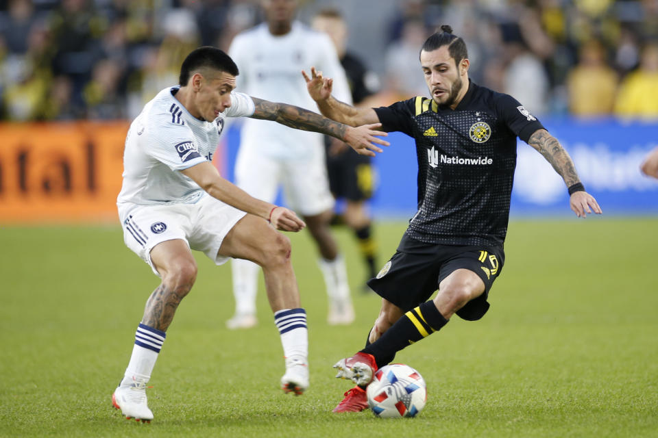 Chicago Fire's Federico Navarro, left, and Columbus Crew's Milton Valenzuela fight for the ball during the second half of an MLS soccer match Sunday, Nov. 7, 2021, in Columbus, Ohio. (AP Photo/Jay LaPrete)