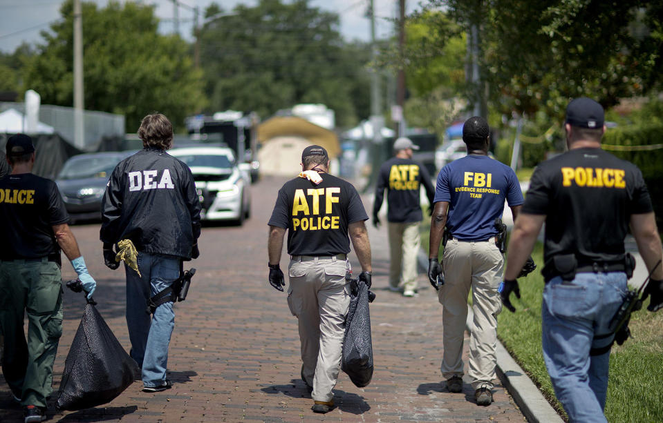 <p>Federal and local law enforcement officials walk through the street next to the scene of a mass shooting at a nightclub on June 13, 2016, in Orlando, Fla. (AP Photo/David Goldman) </p>