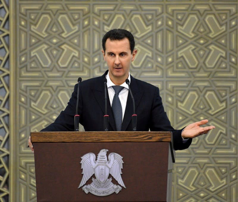 Syria's President Bashar al-Assad speaks during a meeting with heads of local councils, in Damascus