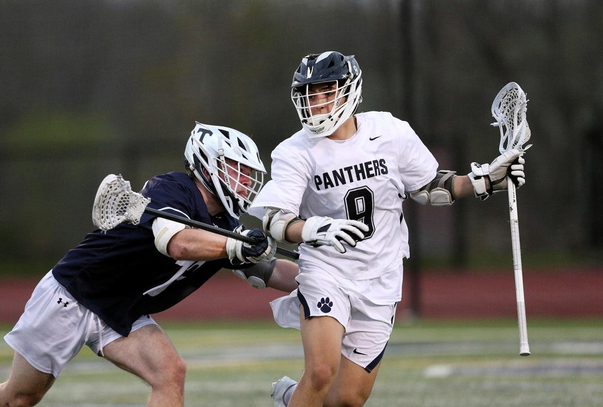 Thomas' Thomas Wolford pushes Pittsford's Rex Kesselring away from the goal May 3, 2022.