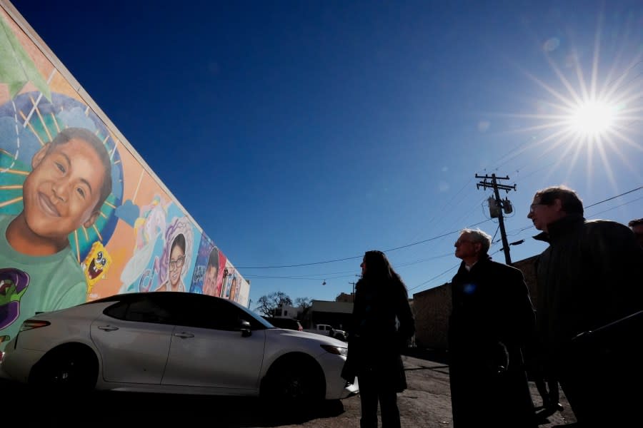 Artist Abel Ortiz, right, gives Attorney General Merrick Garland, center, and Associate Attorney General Vanita Gupta, left, a tour of murals of shooting victims, Wednesday, Jan. 17, 2024, in Uvalde, Texas. The Justice Department is planning this week to release findings of an investigation into the 2022 school shooting. (AP Photo/Eric Gay)