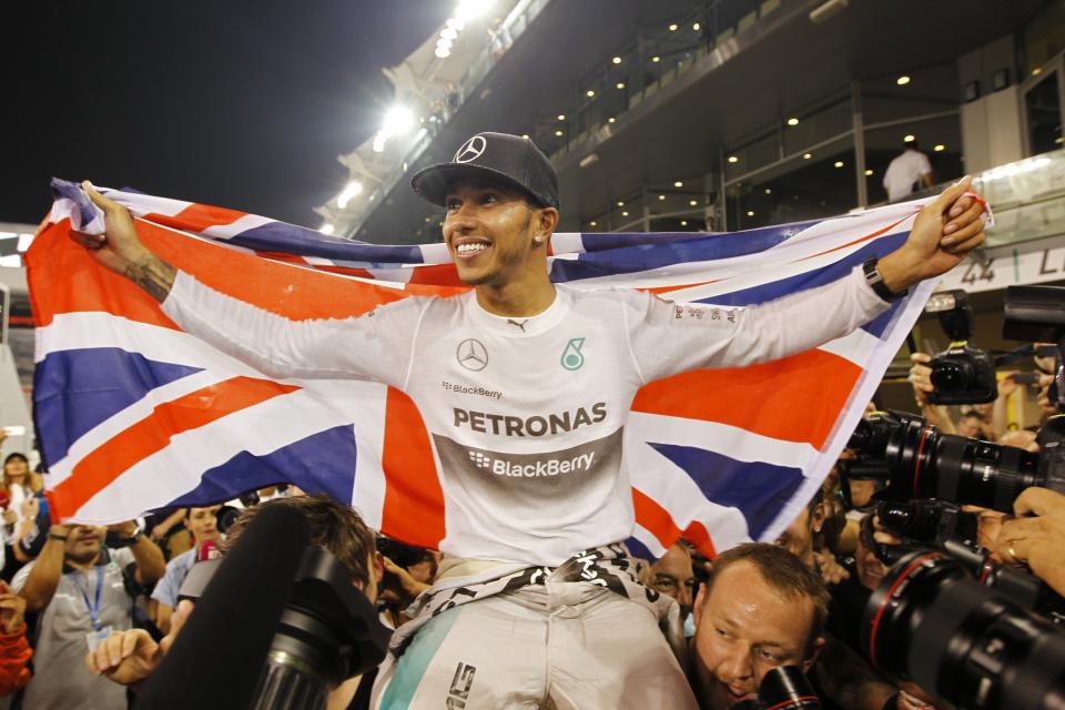 Mercedes Formula One driver Lewis Hamilton of Britain celebrates with his team after winning the Abu Dhabi F1 Grand Prix at the Yas Marina circuit in Abu Dhabi, in this November 23, 2014 file photo. REUTERS/Caren Firouz/Files (UNITED ARAB EMIRATES - Tags: SPORT MOTORSPORT F1 TPX IMAGES OF THE DAY)