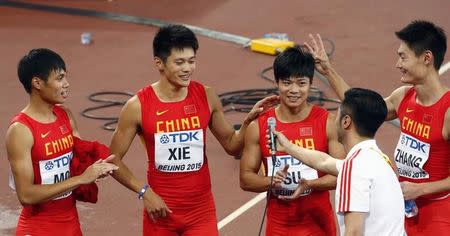 Second placed China's team Mo Youxue, Xie Zhenye, Su Bingtian and Zhang Peimeng (L-R) celebrate as the crow sing happy birthday to Su Bingtian after the men's 4x100 metres relay final during the 15th IAAF Championships at the National Stadium in Beijing, China August 29, 2015. REUTERS/David Gray