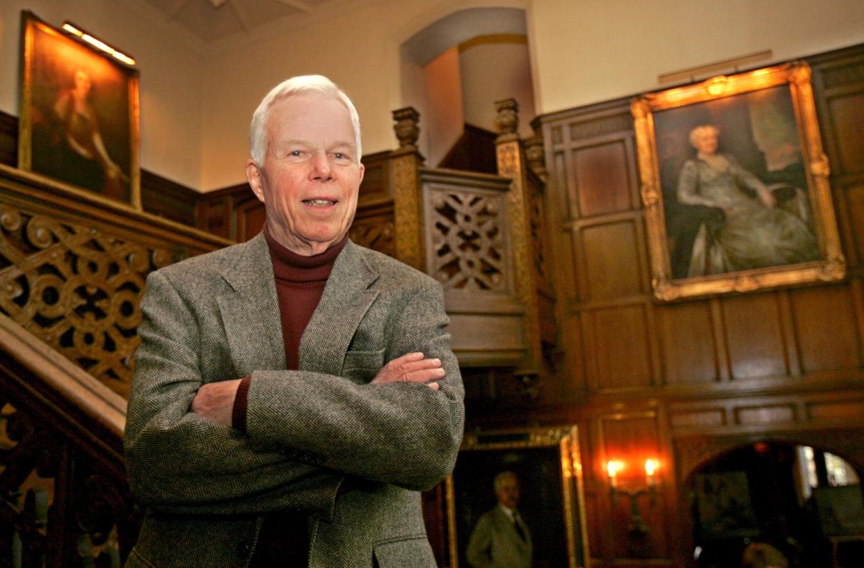 Ned Handy, grandson of Goodyear co-founder F.A. Seiberling, stands on the main stairway at Stan Hywet Hall on Feb. 9, 2005, in Akron. Handy wrote a book about his experiences as a World War II prisoner in the infamous Stalag 17.