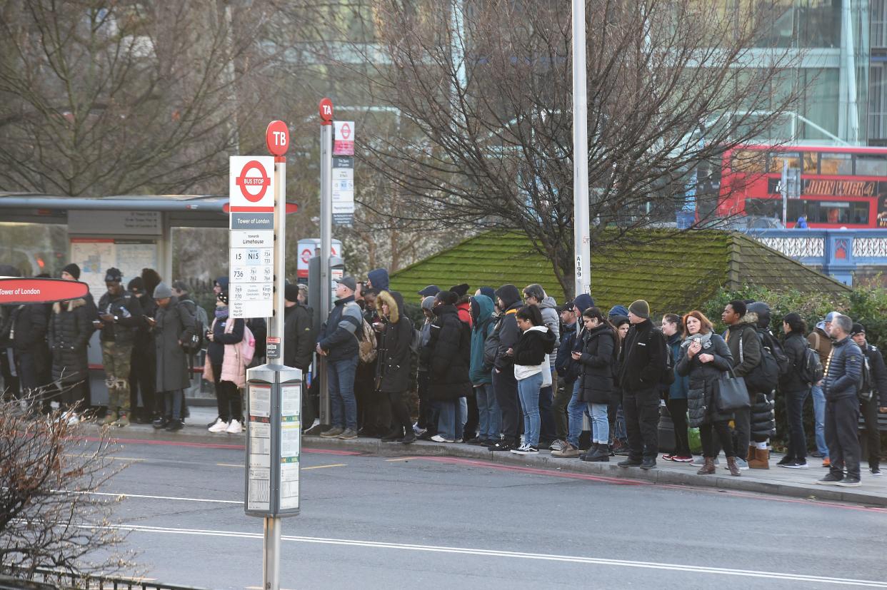 Commuters wait for a bus at Tower Hill (DW Images/Shutterstock)