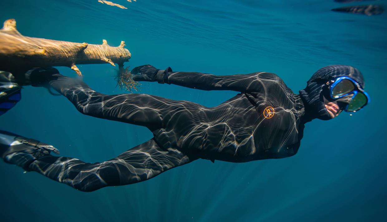 Sam Morrison free dives in the 40-degree water of Clear Lake in Willamette National Forest.