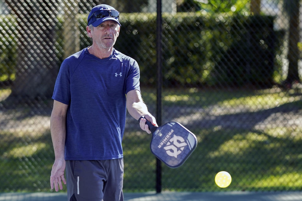 Owen Glick plays pickle ball at Phelps Park, Tuesday, Jan. 17, 2023, in Winter Park, Fla. Glick was among the 233,000 people who left a Western state for another U.S. state out of the region. The U.S. population center is on track this decade to take a southern swerve for the first time in history, and it's because of people like Glick, who moved from California to Florida more than a year ago. (AP Photo/John Raoux)