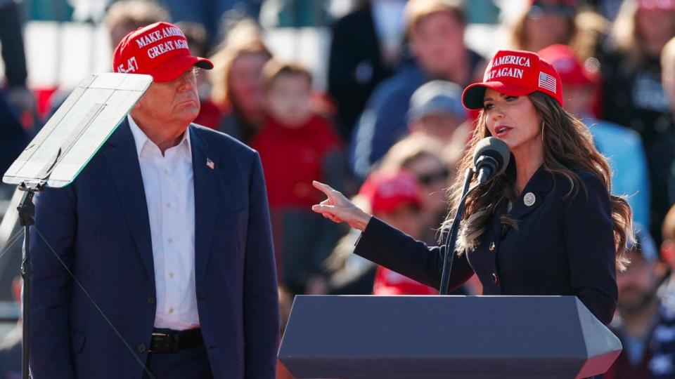 PHOTO: (L-R) Former US President and Republican presidential candidate Donald Trump listens as North Dakota Governor Kristi Noem speaks during a Buckeye Values PAC Rally in Vandalia, Ohio, on March 16, 2024.  (Kamil Krzaczynski/AFP via Getty Images, FILE)