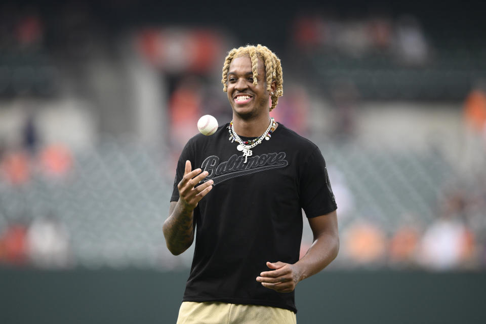 FILE - North Carolina basketball player Armando Bacot pauses before he threw out a ceremonial first pitch before a baseball game between the Baltimore Orioles and the Tampa Bay Rays, Friday, May 20, 2022, in Baltimore. The access to money-making NIL deals have made it easier for star men’s basketball players to consider staying longer in college rather than bolting at the earliest opportunity to pursue NBA or professional careers. (AP Photo/Nick Wass, File)