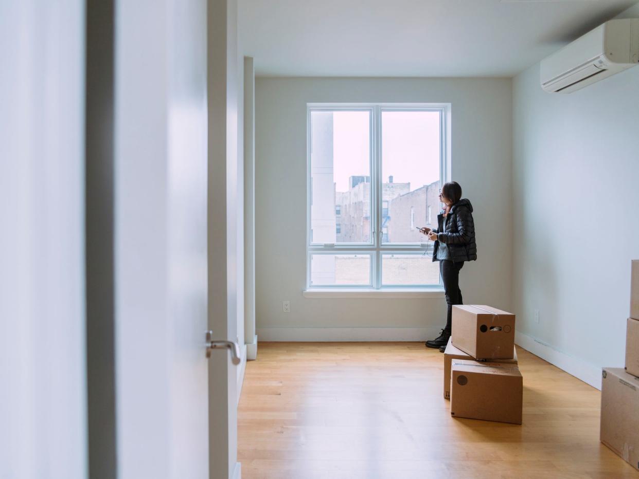 A person standing by an apartment window