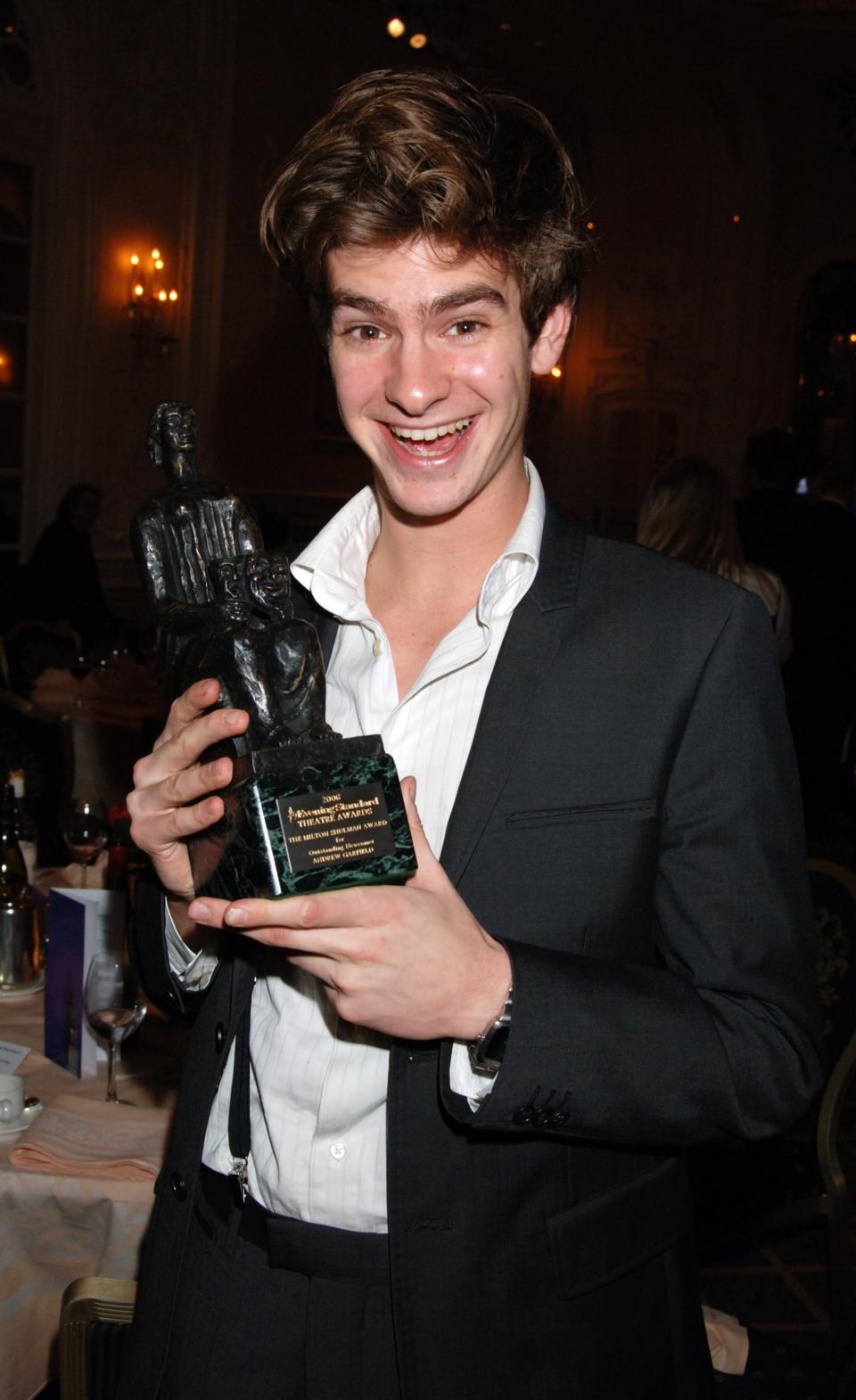 close up of an excited Garfield holding an award