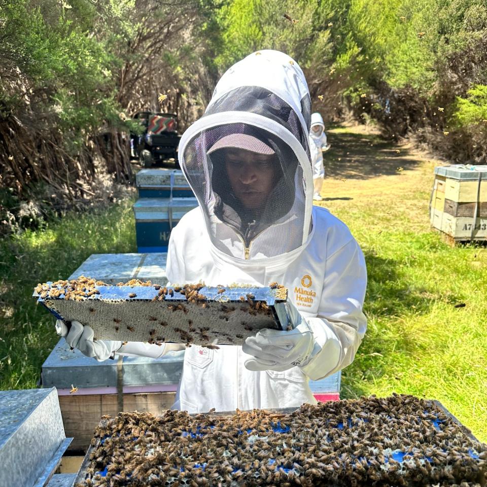 Deena near a beehive in New Zealand