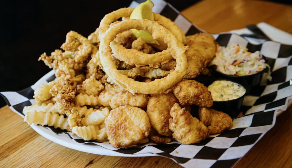 Boston Tavern in West Bridgewater offers this Fenway Triple Play plate with fried clams, scallops, haddock and fries.