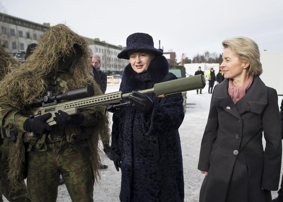 NATO soldier shows off weapons