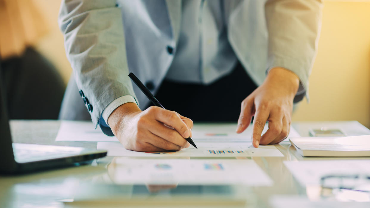 man working on financial documents