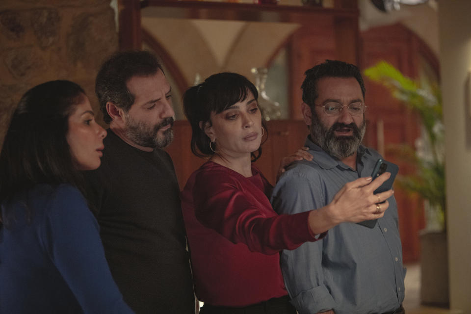 This photo released by Netflix shows characters from the Arabic-language version of the Italian film “Perfect Strangers,” about friends who agree to share their incoming calls, voice and text messages with each other over a dinner party, leading to a series of revelations that test their marriages and friendships. The film’s release has led to a widespread debate in some Arabic-speaking societies, such as Egypt, where some have denounced it as a threat to family and religious values while others praised and defended it.(Rudy Bou Chebel/Netflix via AP)