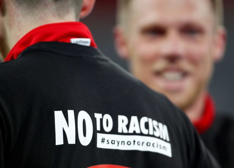 "No to Racism" is written on the warm-up shirt of a Düsseldorf player ahead of the German 2nd Bundesliga soccer match between Fortuna Duesseldorf and VfL Bochum at the Merkur Spiel-Arena. Football has turned a blind eye for too long on racism, according to a German researcher who has called for tougher sanctions against clubs while offenders should be treated in a different way. Roland Weihrauch/dpa