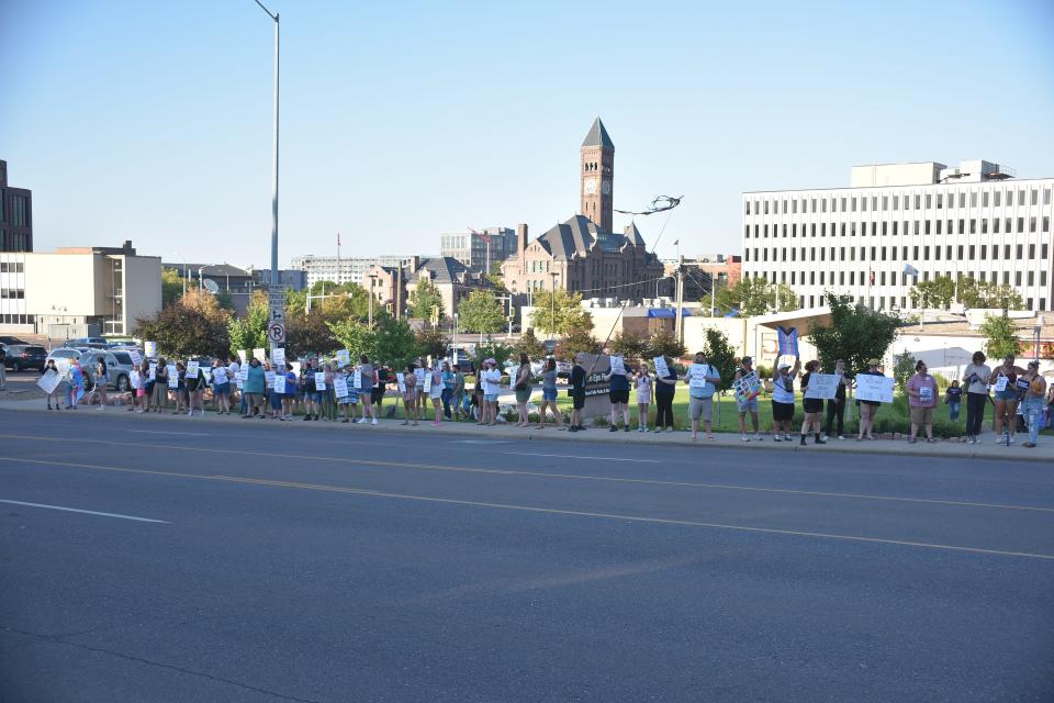 Protesters stand in opposition to House Bill 1080, South Dakota's gender-affirming care ban, as part of a "We Won't Go Back" protest on July 28, 2023 in downtown Sioux Falls at Van Eps Park.