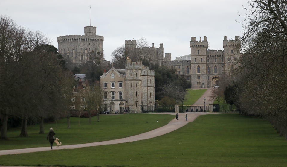 Pedestrians walk the Long Walk in front of Windsor Castle, near the Frogmore Cottage home of Britain's Prince Harry and Meghan Duchess of Sussex in Windsor, Friday, Jan. 10, 2020. Britain's Prince Harry and his wife, Meghan, said they are planning 