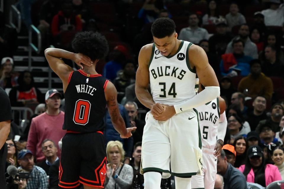 Bucks forward Giannis Antetokounmpo holds his wrist after runing into the stanchion after defending a shot by Bulls guard Coby White on Feb. 16. He will miss Thursday's game against the Nets with right hand soreness.