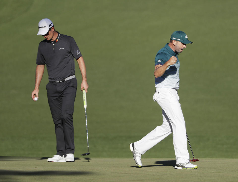 Sergio Garcia, of Spain, reacts in front of Justin Rose, of England, after making an eagle putt on the 15th hole during the final round of the Masters golf tournament Sunday, April 9, 2017, in Augusta, Ga. (AP Photo/David Goldman)