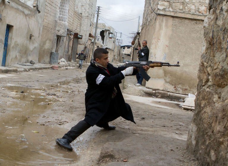 A Syrian rebel aims his weapon during clashes with government forces near Aleppo international airport, on March 4, 2013