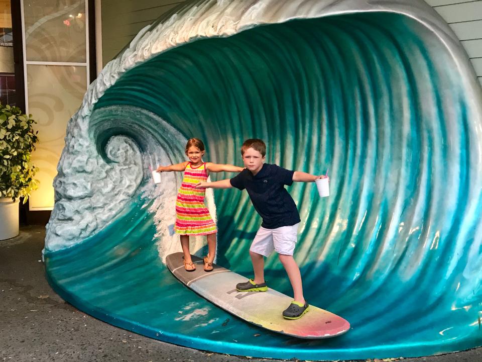 The author's kids on a surfboard and wave set at CityWalk