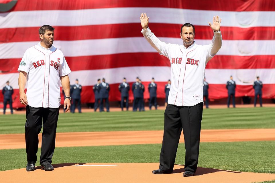 BOSTON, MA - APRIL 13:  Former Boston Red Sox players Jason Varitek and Tim Wakefield throw out the ceremonial first pitch before the home opener between the Boston Red Sox and the Tampa Bay Rays  on April 13, 2012 at Fenway Park in Boston, Massachusetts.  (Photo by Elsa/Getty Images)