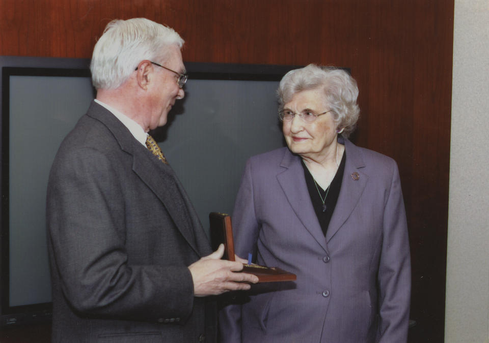 Jack Downing, former CIA deputy director for operations, presents Millie Hewitt in 2005 with her husband’s posthumous Distinguished Intelligence Medal, awarded for his work training and running a team of agents that reported on the deployment of Soviet missiles to Cuba in 1962. (Photo: Courtesy Hewitt family)