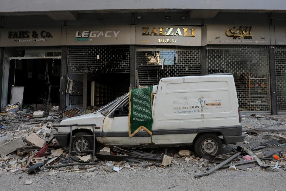 The streets of Beirut’s southern suburbs are lined with debris and battered shopfront (Reuters)