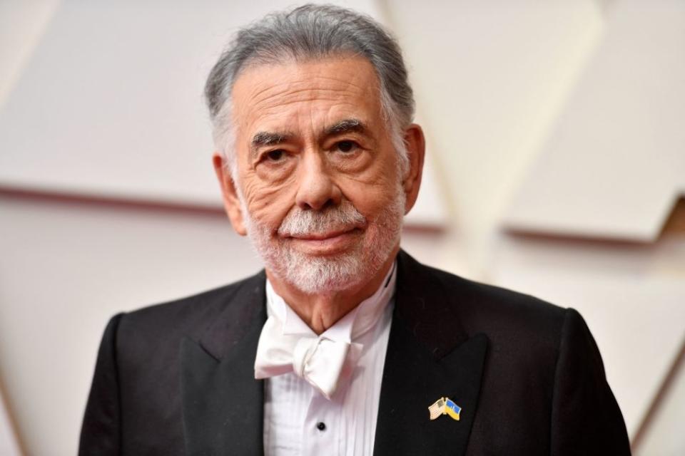 Francis in a tuxedo with bow tie and lapel pin on the red carpet