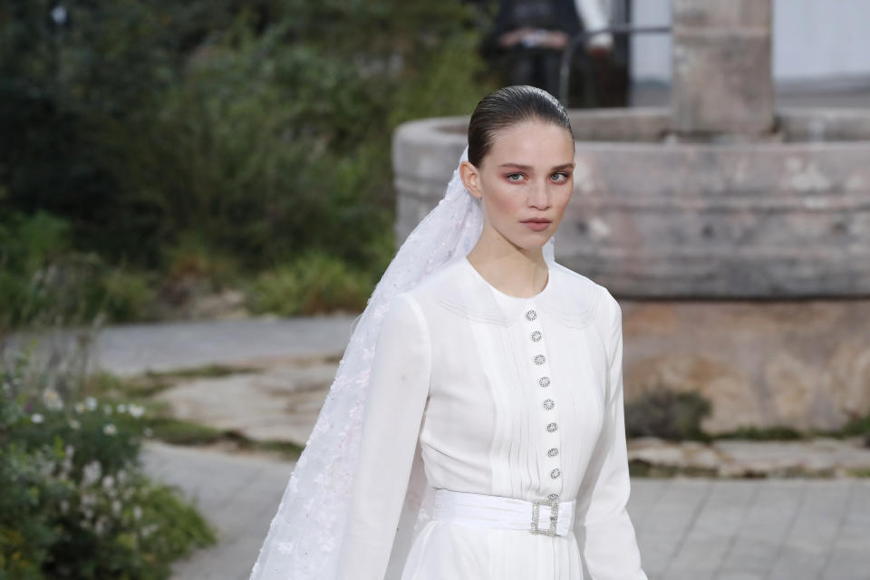 A model wears a creation for the Chanel Haute Couture Spring/Summer 2020 fashion collection presented Tuesday Jan. 21, 2020 in Paris. (AP Photo/Francois Mori)