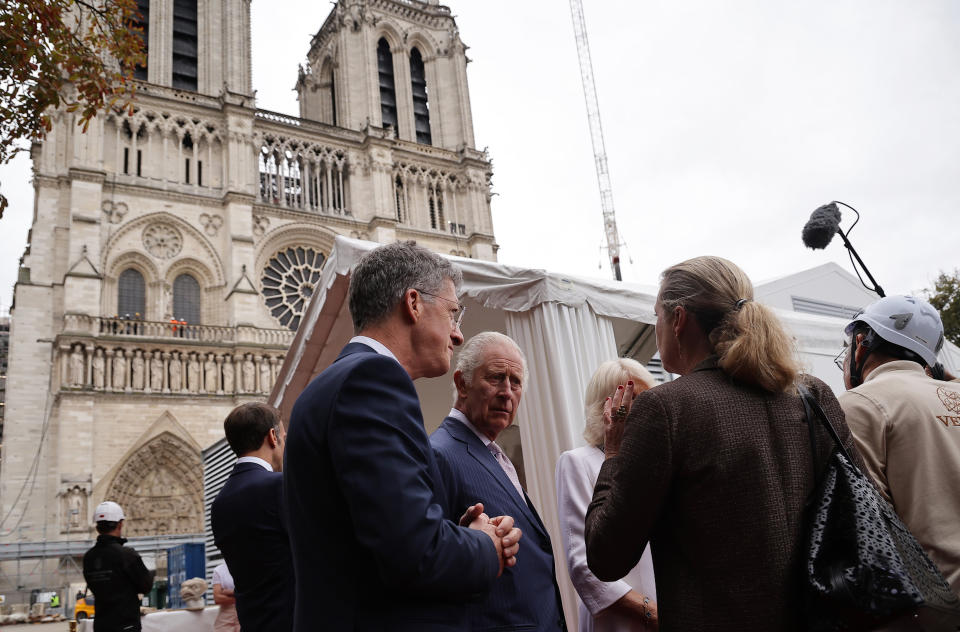Britain's King Charles III, center, visits the Notre-Dame de Paris Cathedral rebuilding site, Thursday, Sept, 21 2023 in Paris. On the second day of his state visit to France, King Charles met with sports groups in the northern suburbs of Paris and pays a visit to fire-damaged Notre-Dame cathedral. (Christophe Petit Tesson, Pool via AP)