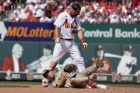 St. Louis Cardinals' Paul Goldschmidt (46) looks down after avoiding the tag from San Diego Padres second baseman Adam Frazier, bottom, for a double during the fifth inning of a baseball game Sunday, Sept. 19, 2021, in St. Louis. (AP Photo/Jeff Roberson)