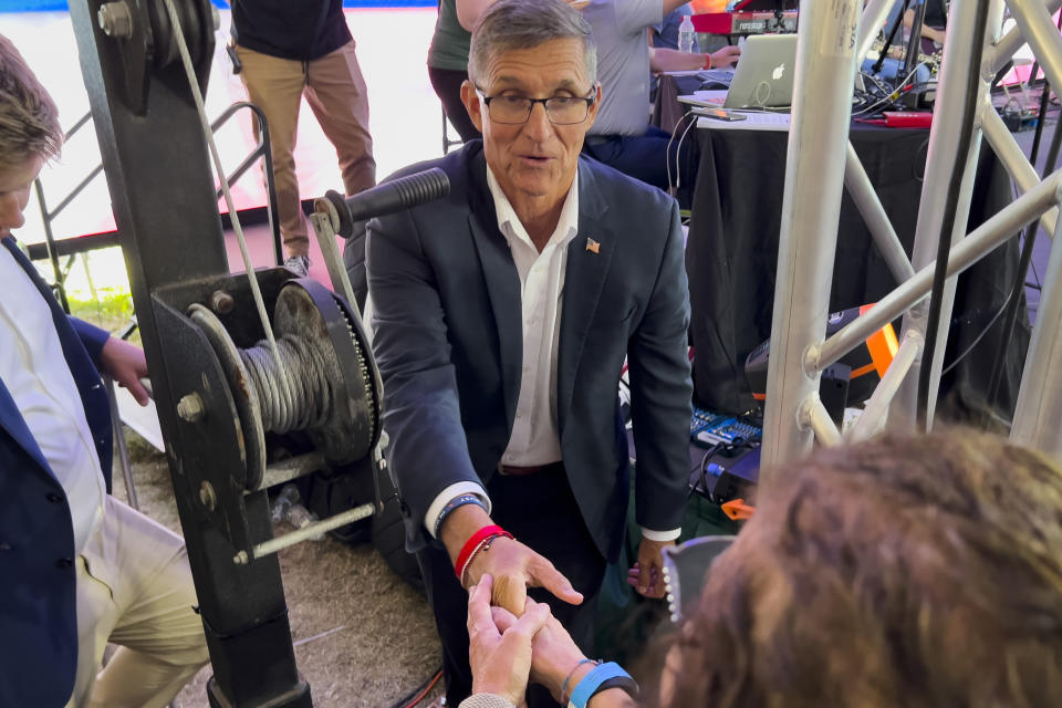 Michael Flynn, a retired three-star general who served as Trump's national security adviser, greets supporters near the stage during the ReAwaken America tour at Cornerstone Church, in Batavia, N.Y., Friday, Aug. 12, 2022. (AP Photo/Carolyn Kaster)