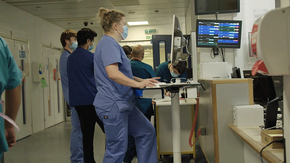 NHS staff in a hospital corridor